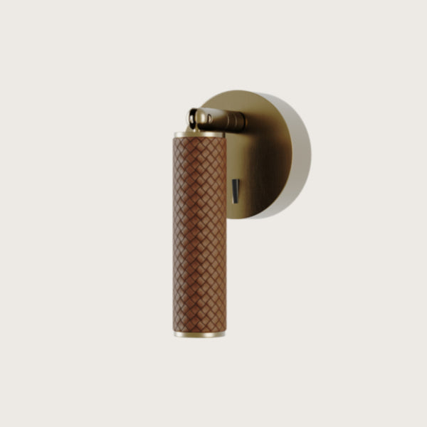 A Wall bedside lamp in leather and brass details from Aromas Del Campo available at Spacio retail stores in Mumbai and Kolkata. 
