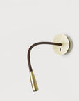 A wall light fixture in metal on a light grey back ground