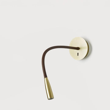 A wall light fixture in metal on a light grey back ground