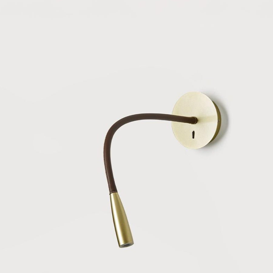 A wall light fixture in metal on a light grey back ground