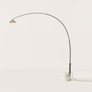 A modern design floor lamp in marble and metal on light cream colour background
