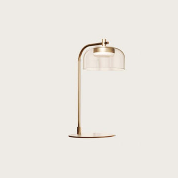 A modern design table lamp in brass and clear glass from Aromas Del Campo available at Spacio retail stores in Mumbai & Kolkata. 
