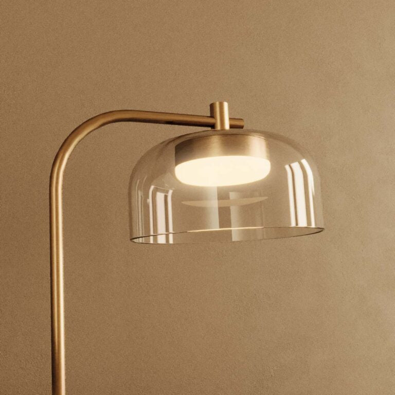 Close up of a modern design table lamp in brass and clear glass from Aromas Del Campo available at Spacio retail stores in Mumbai & Kolkata. 
