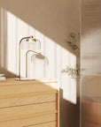 A table lamp on a wooden side board in a Scandinavian theme interior.