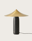 A table lamp in black marble and brass shade from Aromas Del Campo on a white background available at Spacio retail stores in Mumbai & Kolkata