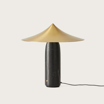 A table lamp in black marble and brass shade from Aromas Del Campo on a white background available at Spacio retail stores in Mumbai & Kolkata