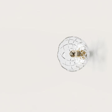 A crystal wall lamp on light beige colour background from Aromas Del Camp available at Spacio retail stores in India. 
