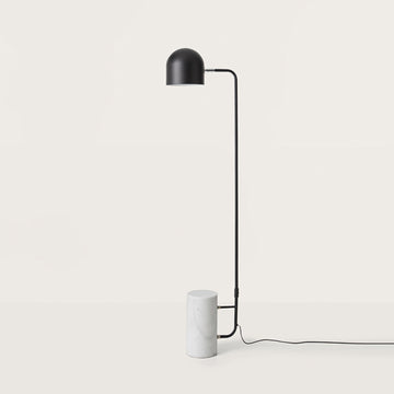 A modern design floor lamp in metal and marble on a light grey colour background from the Luca collection of lights from Aroma Del Campo, available at Spacio retail stores in India. 