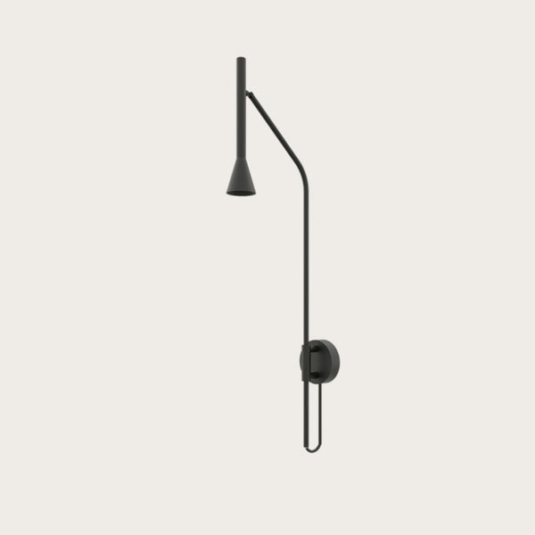 A long black colour metal wall light on a cream colour wall