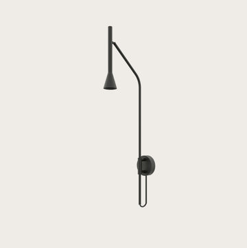 A long black colour metal wall light on a cream colour wall