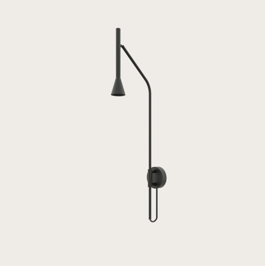A long black colour metal wall light on a cream colour wall