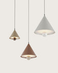 3 modern pendant lamps in different colours suspending from ceiling 