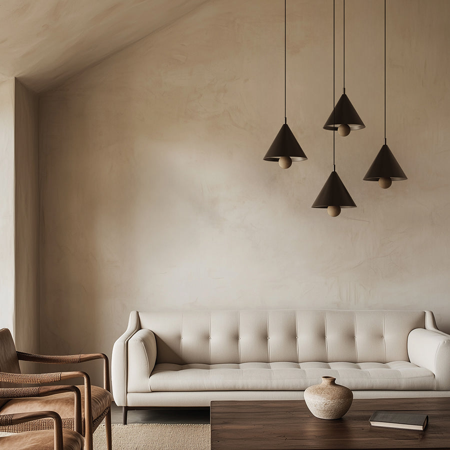 4 modern pendant lamps in black colour  suspending from ceiling above a modern design sofa in a Japandi style interiors