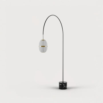 A tall floor lamp with marble base and brass detailing from Aromas Del Campo available at Spacio retail stores in Mumbai & Kolkata. 