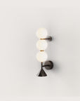 A modern design wall sconce in glass and black marble from Aromas Del Campo available at Spacio retail stores in Mumbai & Kolkata. 