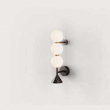 A modern design wall sconce in glass and black marble from Aromas Del Campo available at Spacio retail stores in Mumbai & Kolkata. 