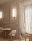 A modern styling restaurant with chairs and table along with wall lights. 