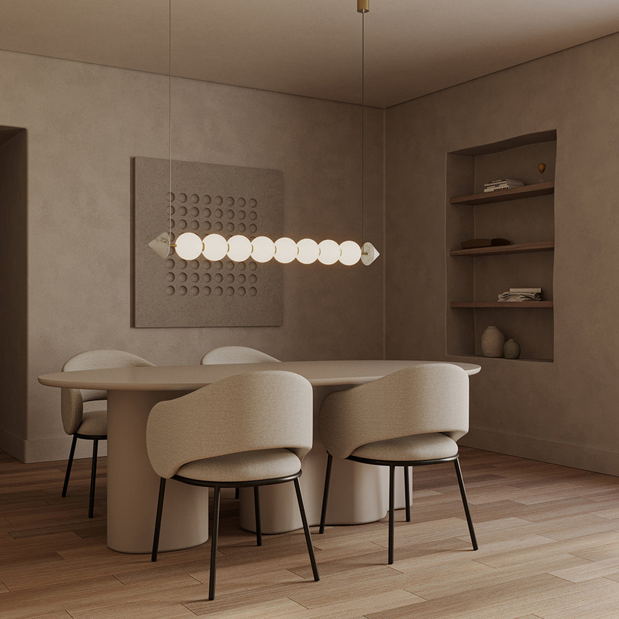 A Japandi theme dining room with artefacts, dining table, chairs, wall art and suspended light. 