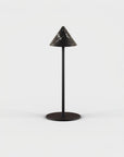 Black cone-shaped lamp on a white background from Aromas Del Campo available at Spacio retail stores in Mumbai & Kolkata. 