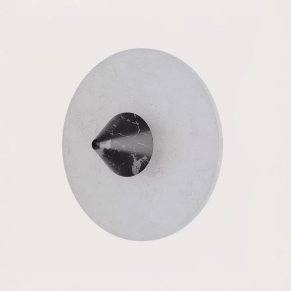 A wall light in black marble and alabaster from Aromas Del Campo available at Spacio retail stores in Mumbai & Kolkata
