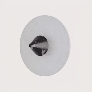 A wall light in black marble and alabaster from Aromas Del Campo available at Spacio retail stores in Mumbai & Kolkata