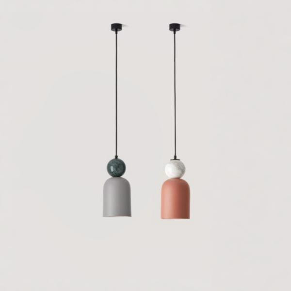 A pair of colourful pendant lights hanging from the ceiling in marble and ceramic from Aromas del campos available at Spacio retail stores in Mumbai & Kolkata. 