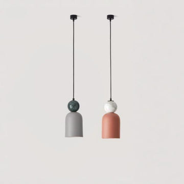A pair of colourful pendant lights hanging from the ceiling in marble and ceramic from Aromas del campos available at Spacio retail stores in Mumbai & Kolkata. 