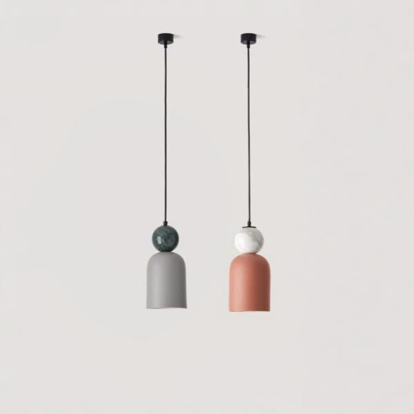 A pair of colourful pendant lights hanging from the ceiling in marble and ceramic from Aromas del campos available at Spacio retail stores in Mumbai & Kolkata. 