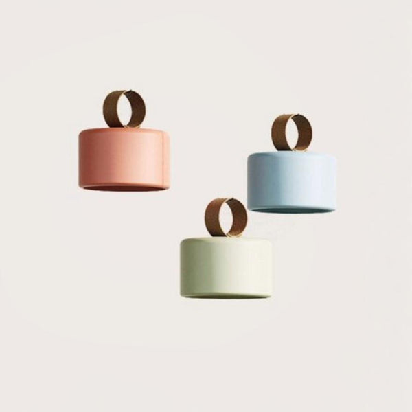 3 Multicolour rechargeable and portable pendant lamps from Aromas del camp on a light grey background available at Spacio retail stores in Mumbai & Kolkata. 
