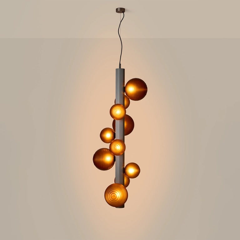 A lit up decorative suspension lamp hanging from the ceiling, by Aromas Del Campo available at Spacio retail stores in Mumbai & Kolkata. 
