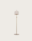 A floor lamp from Aromas Del Campo on a light cream background with metal shade in the shape of 2 petal flower