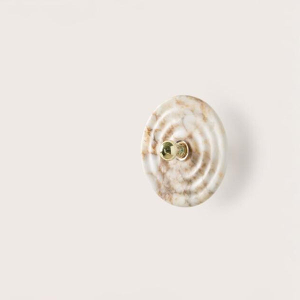 A wall light called WAVE from Aroma Del Campo made of alabaster, available at Spacio retail store in Mumbai & Kolkata. 