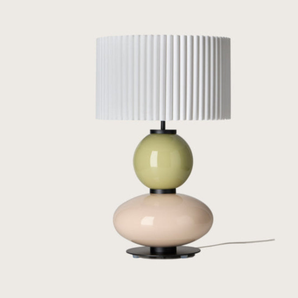Modern table lamp with a yellow and white glass base and a pleated shade from Aromas. Available at Spacio retails stores in India. 