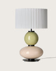 Modern table lamp with a yellow and white glass base and a pleated shade from Aromas. Available at Spacio retails stores in India. 