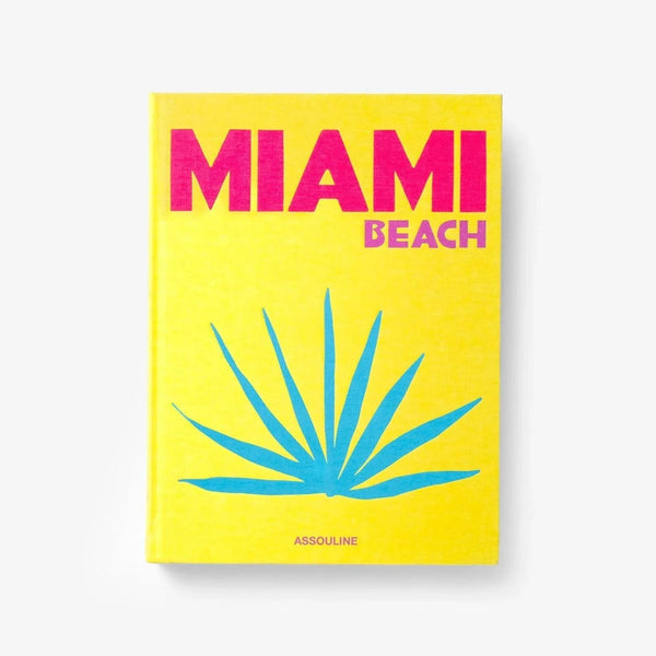 On a white background a luxurious Miami Beach coffee table book by Assouline, featuring vibrant photography and elegant design, available at Spacio India for collectors and decor enthusiasts.