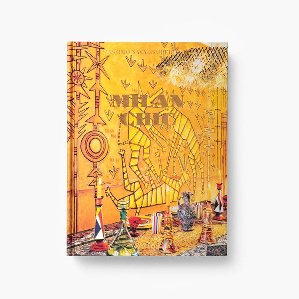 On a white background an artistic cover featuring a vibrant mural and eclectic glassware, reflecting Milan‚Äôs rich design heritage in luxurious Assouline Milan Chic coffee table book, showcasing Milan‚Äôs timeless elegance, now available at Spacio India‚Äôs online store and retail outlets.