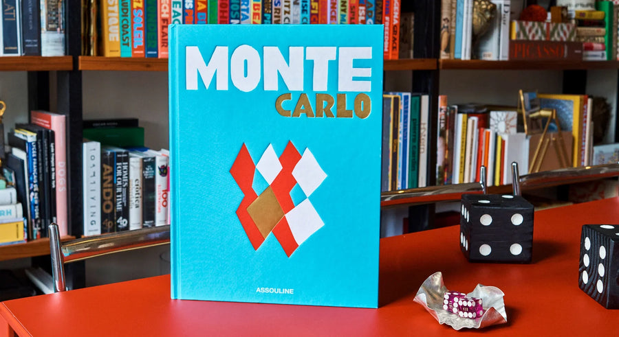 A bold turquoise Front cover in a Assouline's Monte Carlo coffee table book, featuring a vibrant cover with images of Monaco's iconic landmarks, available at Spacio India.