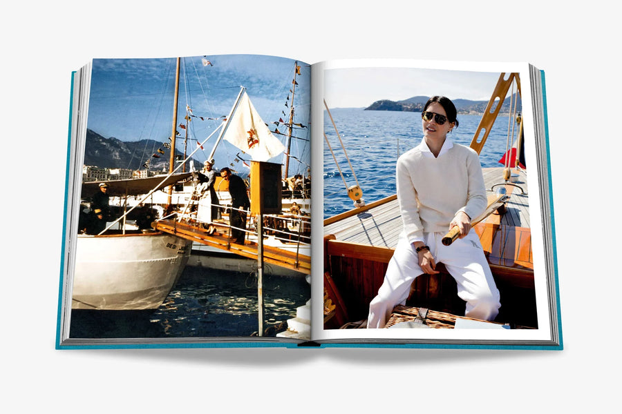 Double spread page of a classic vintage yacht scene and a stylish man in white enjoying a sailing experience on a wooden boat in luxurious Assouline's Monte Carlo coffee table book, featuring a vibrant cover with images of Monaco's iconic landmarks, available at Spacio India.