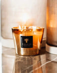 Lit Baobab Aurum Candle Max 10 on marble surface with warm glow - luxury scented decor from Spacio India