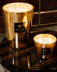 Pair of Baobab Aurum Candles lit on luxury wood table - exclusive fragrance experience from Spacio India