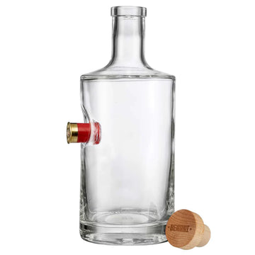 Clear glass decanter with a unique design, featuring an empty shotgun shell, on a white background from the American brand Benshot available at Spacio retail stores in Mumbai & Kolkata. 
