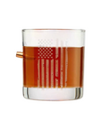 Clear glass with American flag design filled with bourbon whiskey on a white background