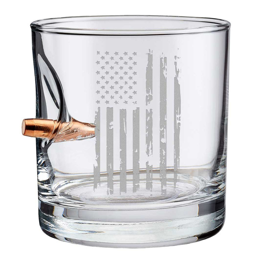 Clear whiskey glass with American flag engraving and bullet on a white background from the American brand Benshot available at Spacio retail stores in Mumbai & Kolkata. 