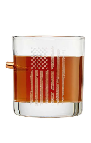 Clear glass with American flag design filled with bourbon whiskey on a white background