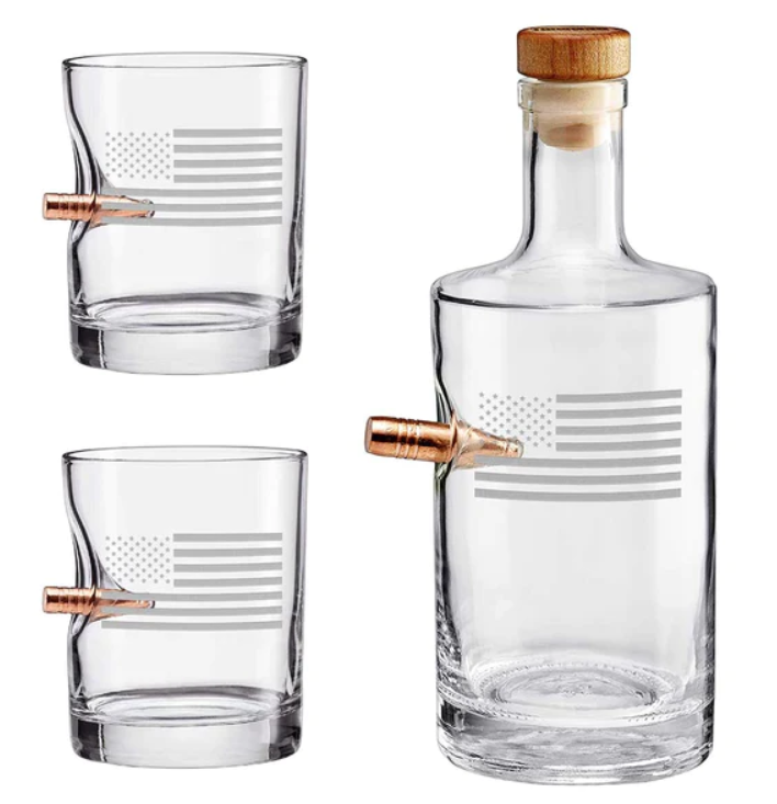 Clear whiskey glass decanter and two glasses with bullet on a white background from the American brand Benshot available at Spacio retail stores in Mumbai & Kolkata. 