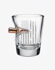Clear glass shot glass with a bullet-shaped handle on a white background from the American brand Benshot available at Spacio retail stores in Mumbai & Kolkata. 