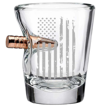 Clear glass shot glass with a bullet-shaped handle on a white background from the American brand Benshot available at Spacio retail stores in Mumbai & Kolkata. 