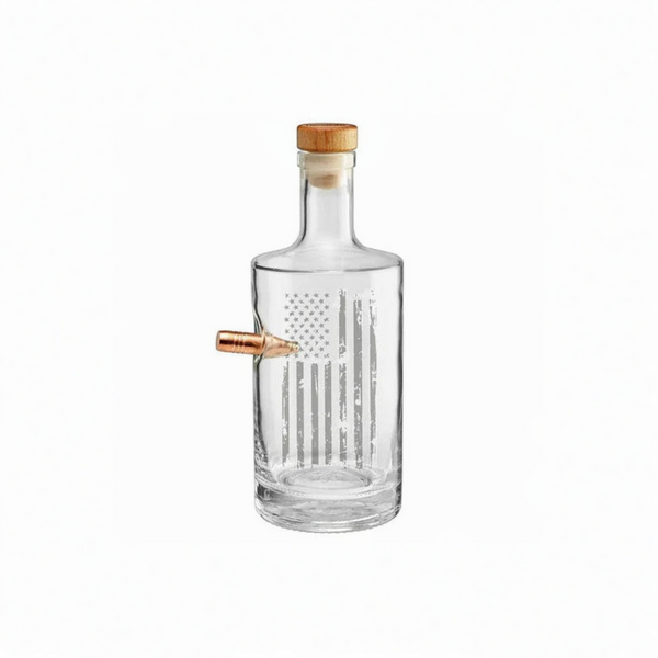 Clear whiskey decanter with a wooden cap and real bullet on a white background from the American brand Benshot available at Spacio retail stores in Mumbai & Kolkata. 
