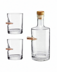 Clear glass whiskey decanter and two glasses with bullet on a white background from American brand Benshot available at Spacio retail stores in Mumbai & Kolkata. 