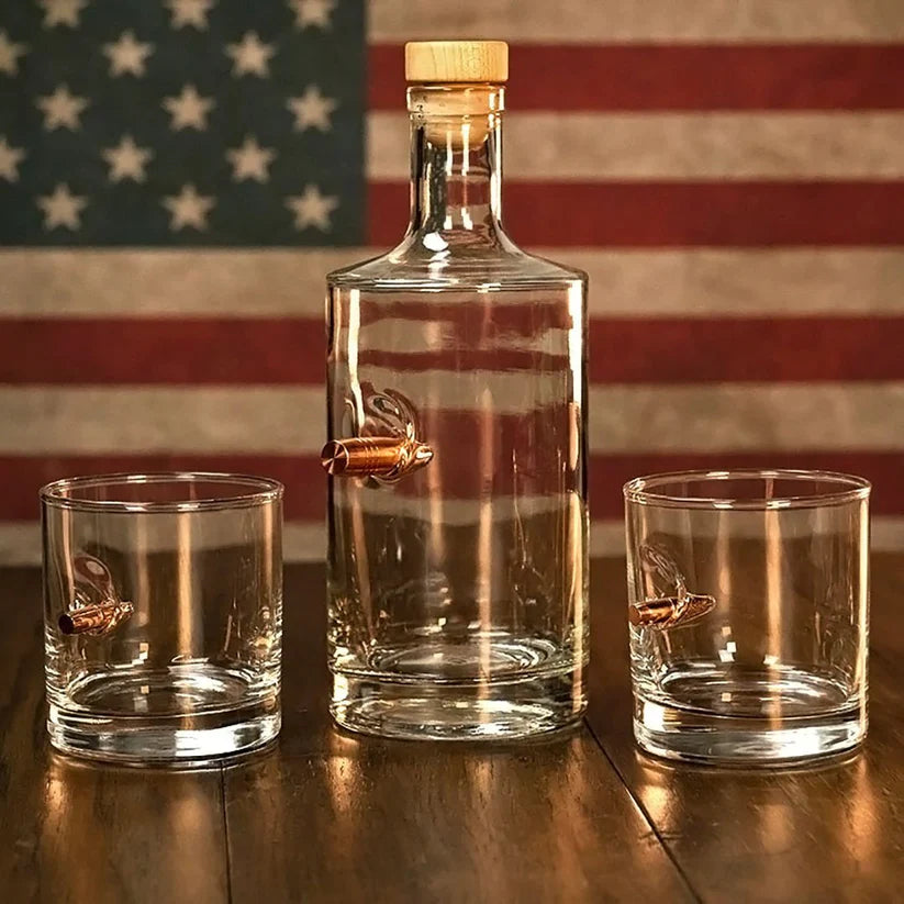 Whiskey decanter and 2 whisky glass with bullets in front of American flag background